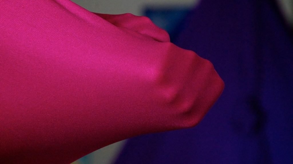 Close-up of a stretchy fabric being pulled to show elasticity and durability