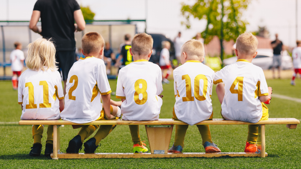 kids wearing gold and white colored jerseys