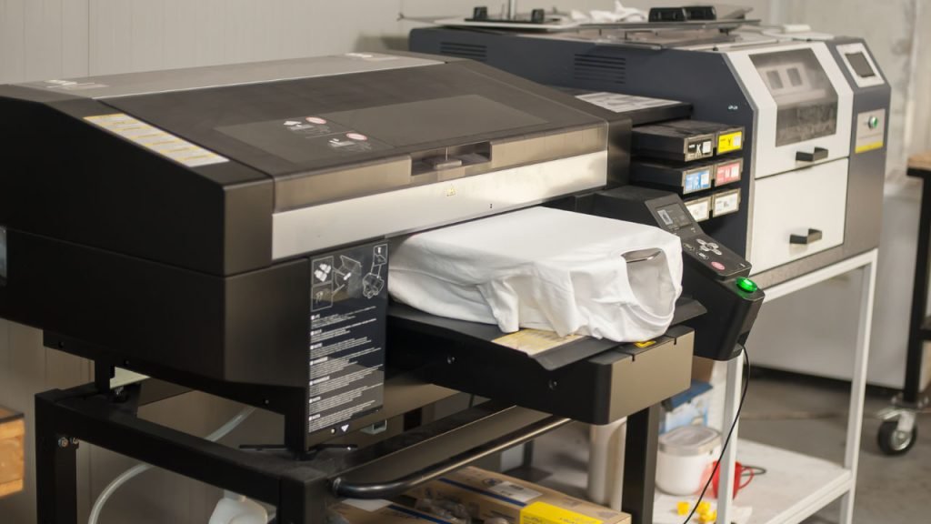 A shirt fed into a digital printer.