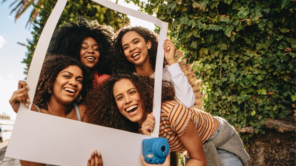 friends posing inside a frame