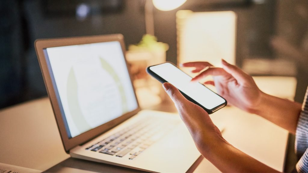 using a mobile phone and a laptop